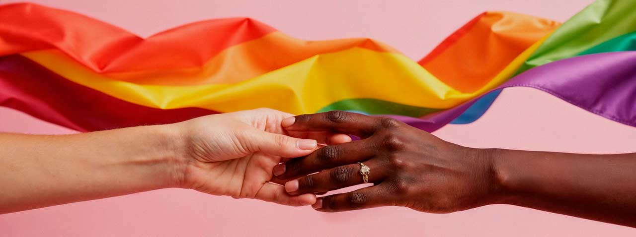 hands meeting rainbow flag pride